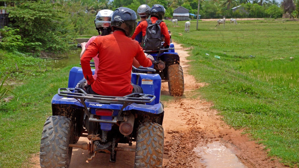 ATV riding pairs on dirt path in Siem Reap