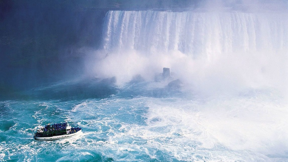 tour boat nearing the base of the waterfall in Canada