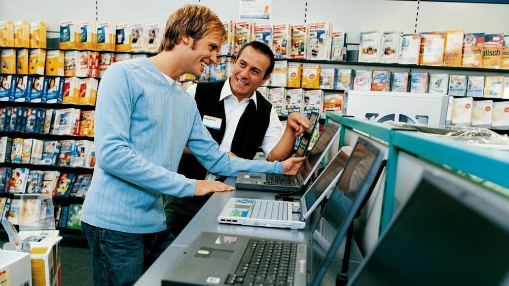man shopping for a laptop at an electronics store in Paraguay