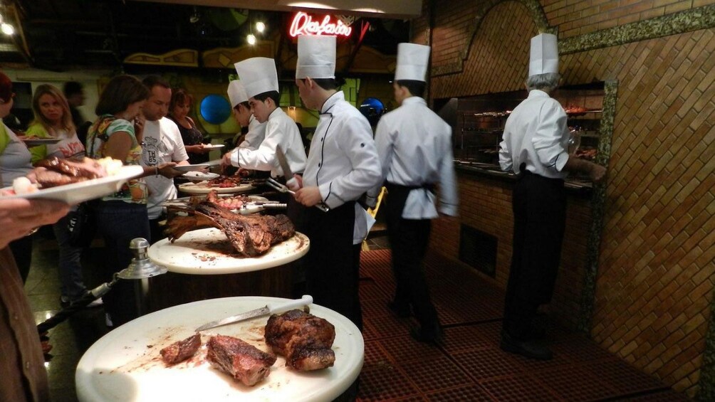 chefs serving steaks at the Raffain Dinner Show in Brazil