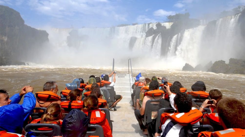 boat full of passengers exploring the waterfalls in Argentina