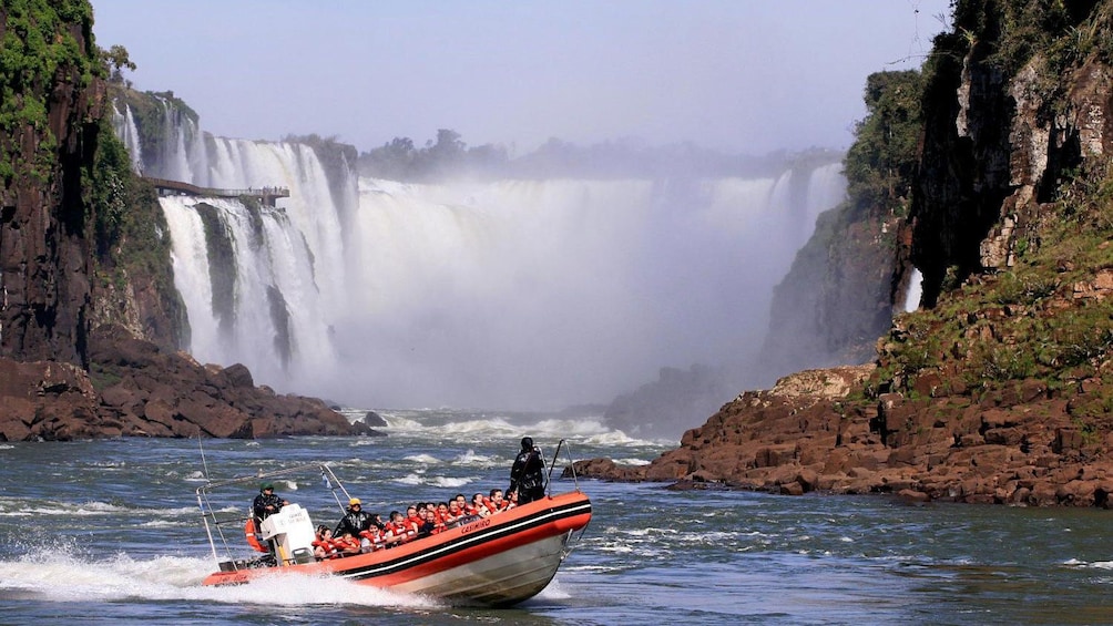 crowded boat speeding along the waterfalls in Brazil