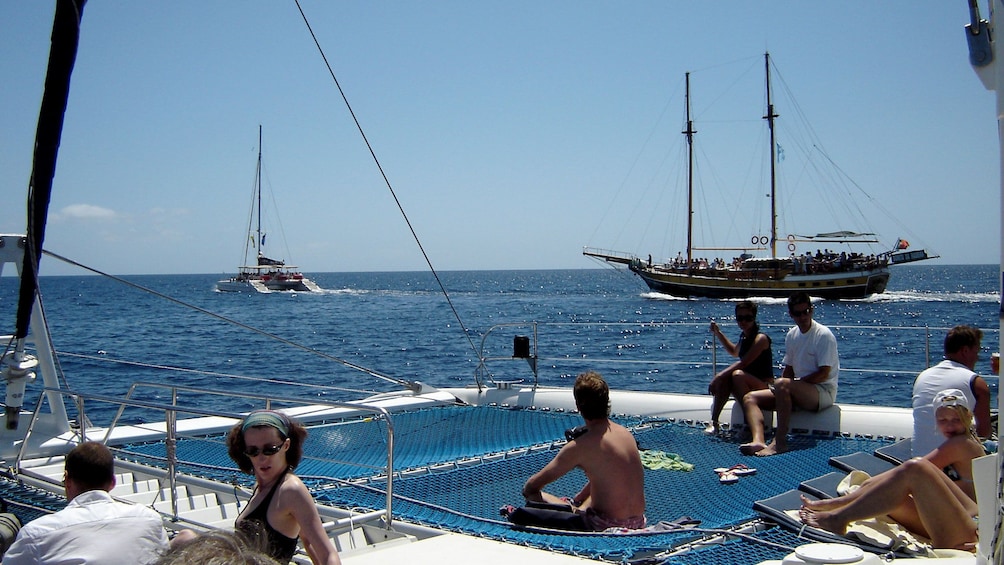 People lounging in the sun on a catamaran in Madeira Island