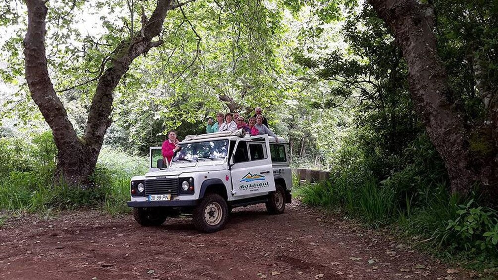 Tour group in a jeep on a dirt road in Madeira Island