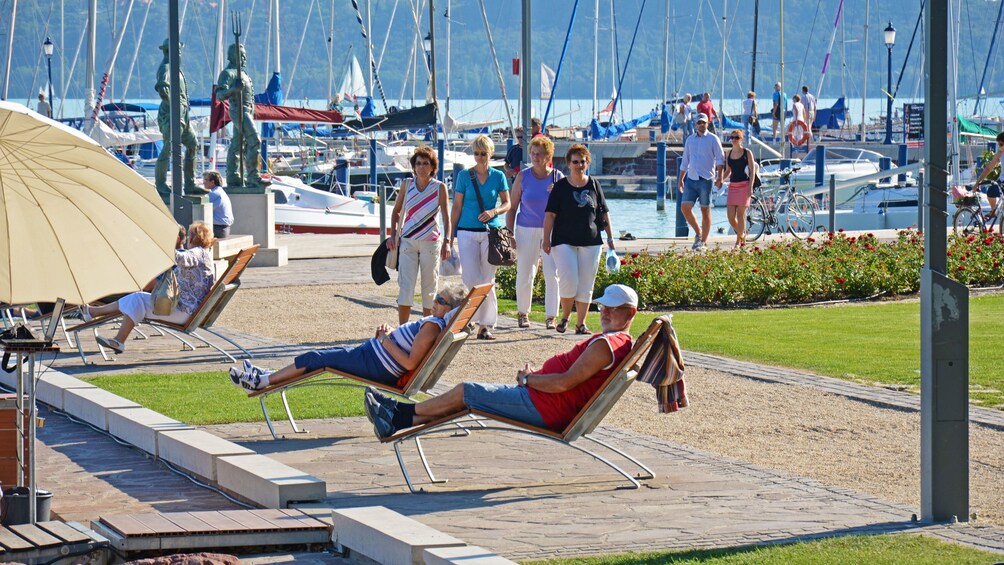 People relaxing by the shore of Lake Balaton