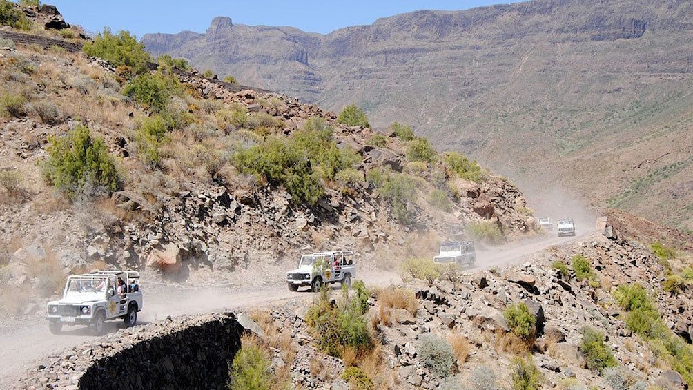 Jeeps on a winding hillside road in Gran Canaria