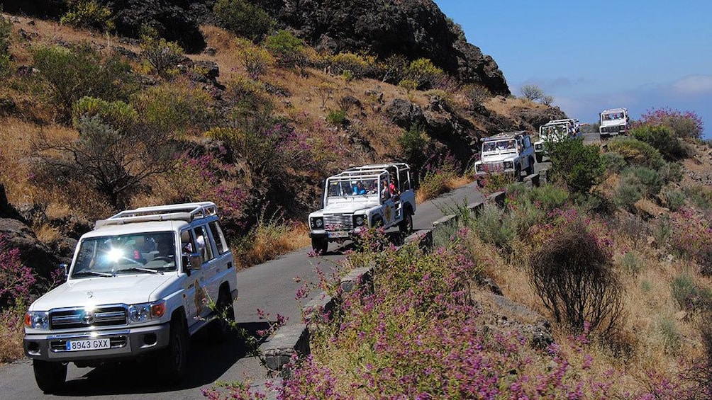 Line of jeeps on a hillside road in Gran Canaria