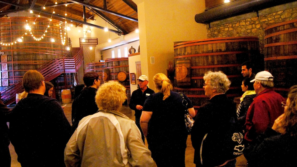 inside the well lit winery with large barrels in San Francisco