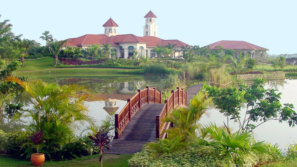 Pun Hlaing Golf Club pond and bridge with clubhouse in the distance in Myanmar