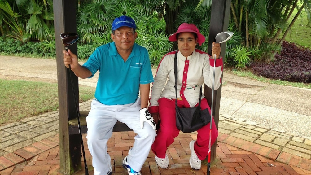 Golfing couple taking a break at the Pun Hlaing Golf Club in Myanmar