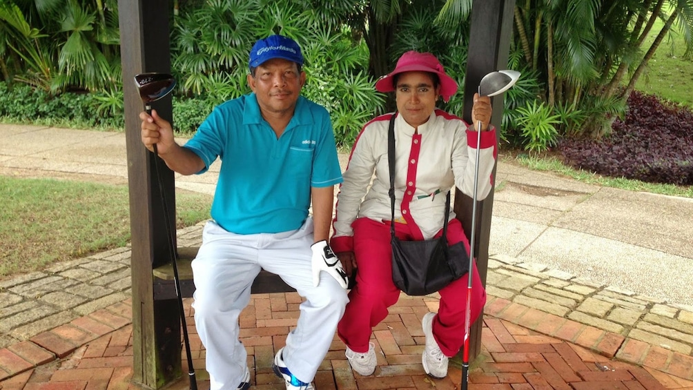 Golfing couple taking a break at the Pun Hlaing Golf Club in Myanmar