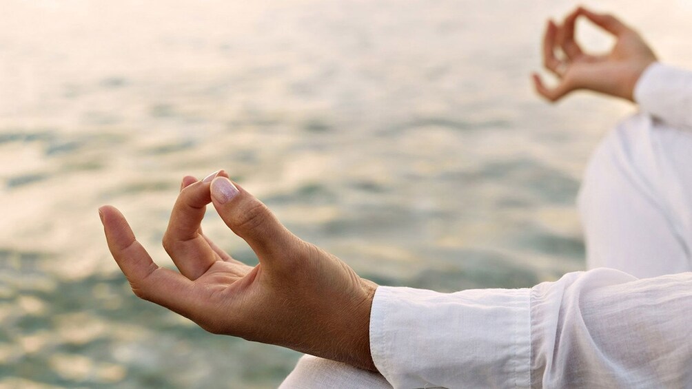 Hands of a person meditating at Mahasi Meditation Center in Myanmar