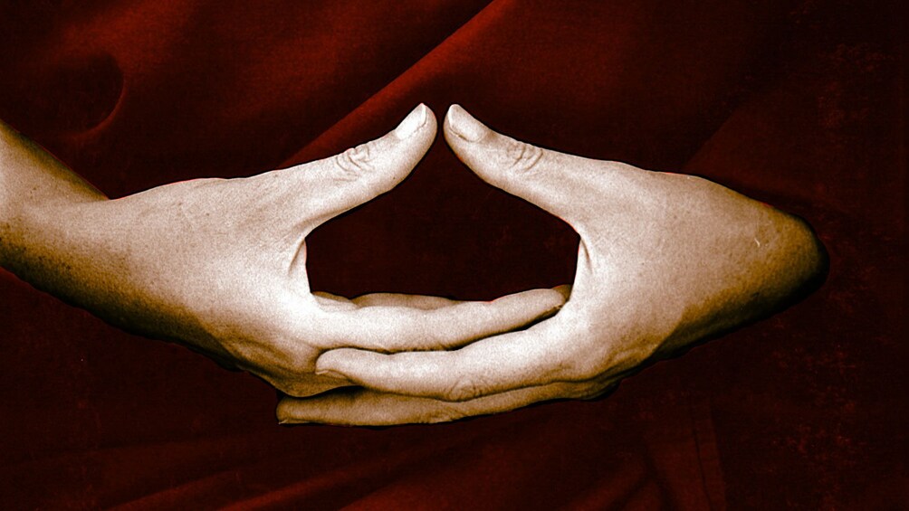 Clasped hands of a monk at the Mahasi Meditation Center in Myanmar