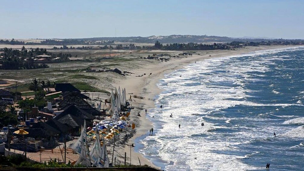beachgoers enjoying the waves on a sunny day in Natal