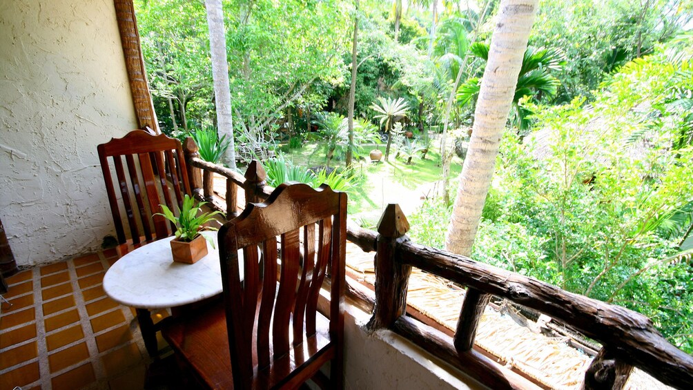 Covered dining table with a view of the surrounding jungle at a hotel in the  Kanchanaburi Province