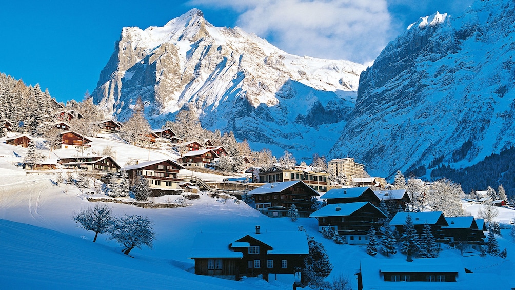Small snow-topped village nestled in the mountains in Grindelwald