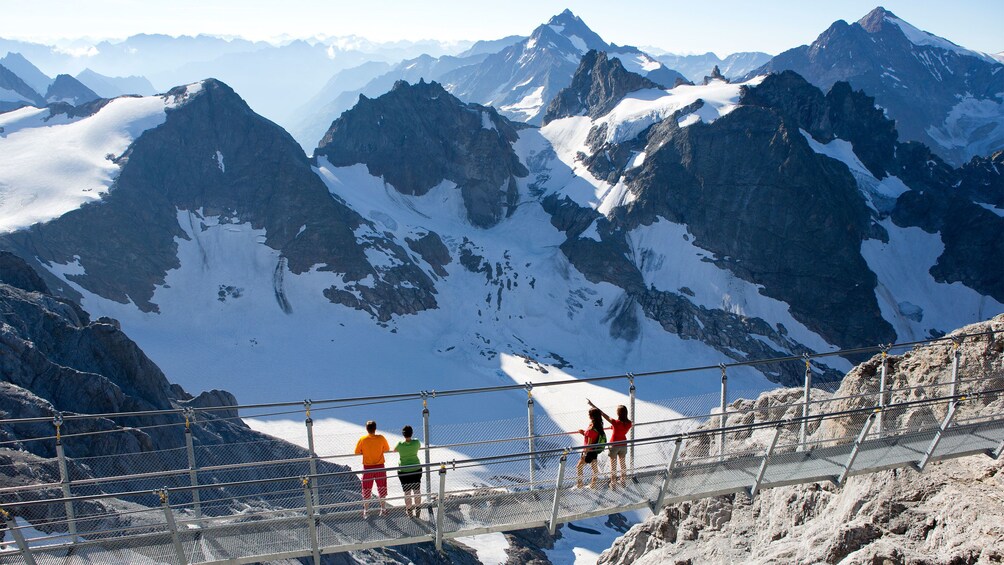 Tour group on the Cliff Walk bridge on Mount Titlis in Switzerland