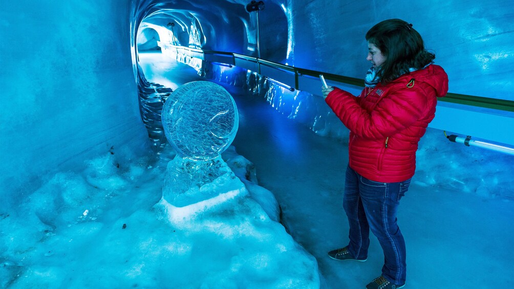 Woman in the glacial tunnel of the Ice Grotto on Mount Titlis in Switzerland