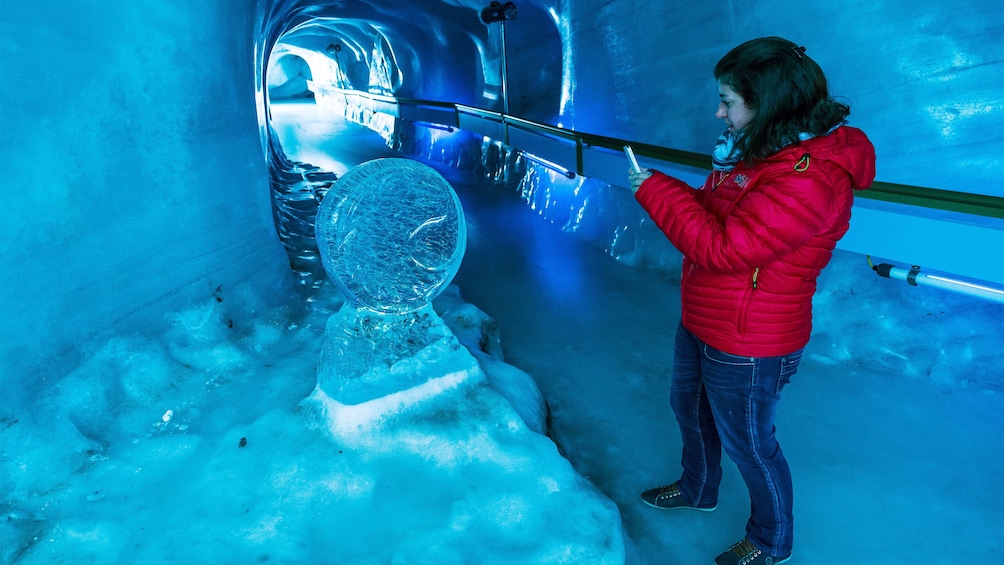 Woman in the glacial tunnel of the Ice Grotto on Mount Titlis in Switzerland