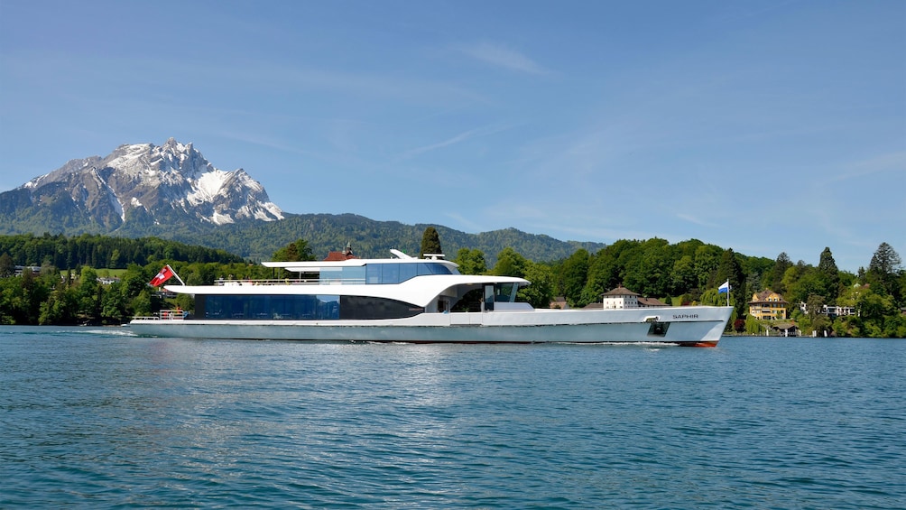 Tour boat on the water with mountain in the background in Lucerne