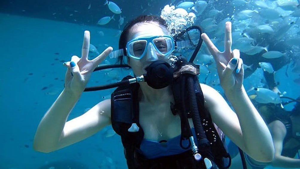A scuba diver flashing a peace sign in Antalya
