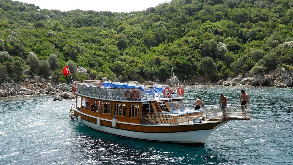 People on a boat near the shore of Kemer