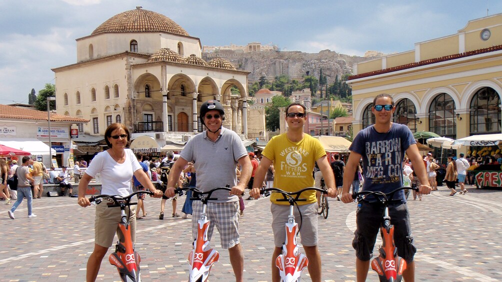 Show item 1 of 5. group on electric tri scooters exploring the city of Athens