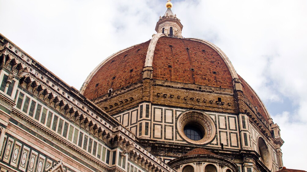 walking past the red dome of the Historic Centre of Florence in Italy