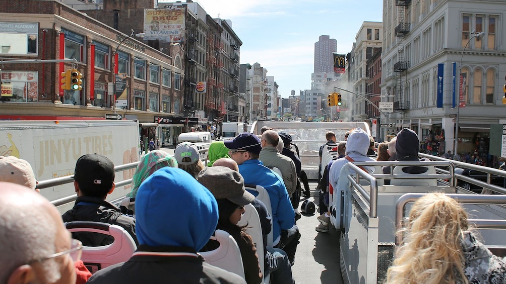 Tourists board a double decker bus to see NYC
