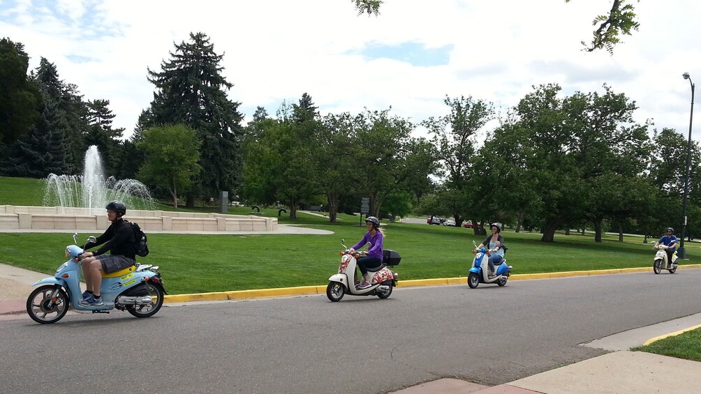Tourists exploring Denver via scooter