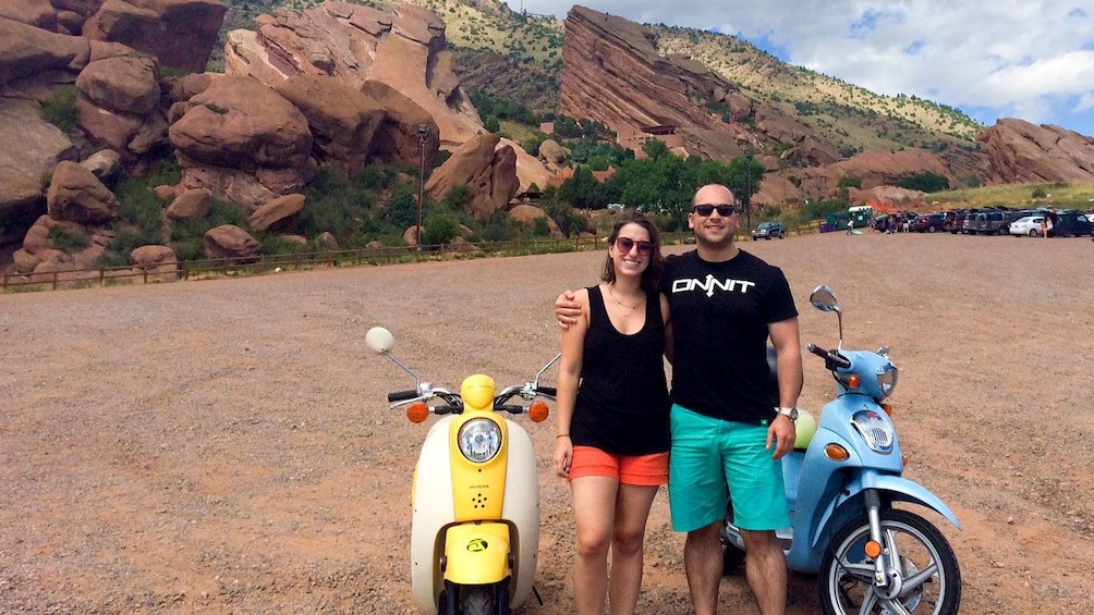 Couple embarking on a scooter tour around Denver