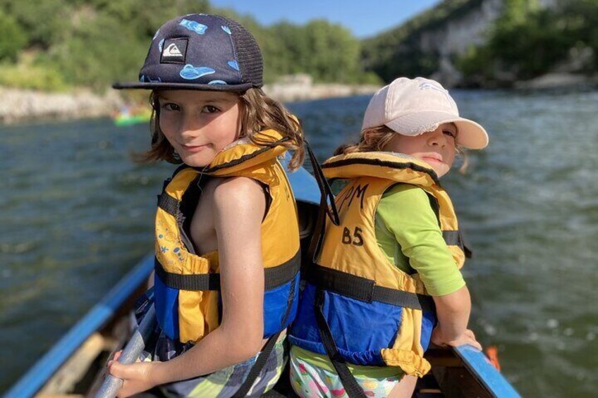 Young non-swimming children traveling in the guide's canoe