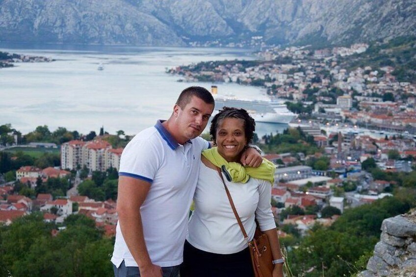 Montenegrin hug at panorama of Kotor Bay.