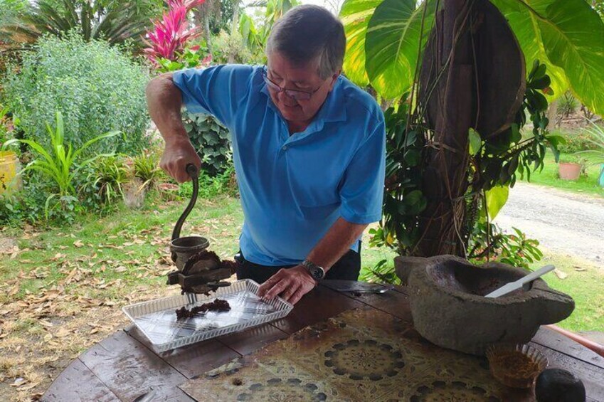 Chocolate tour, Matt begins the cocoa grinding process