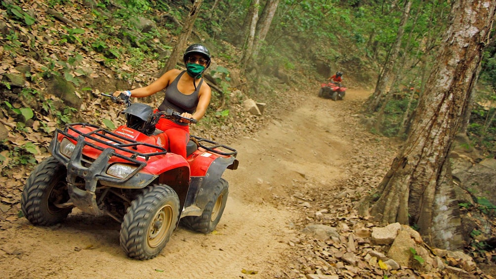 ATV riding woman on a dirt path in the woods in Puerto Vallarta