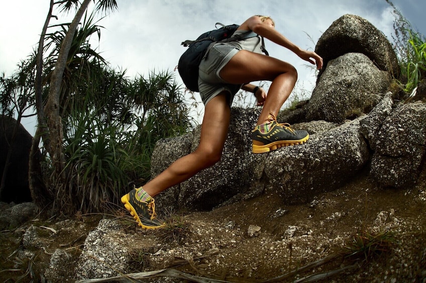 Hiker makes way up boulders