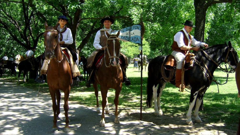 group in colonial costumes riding horses in Argentina