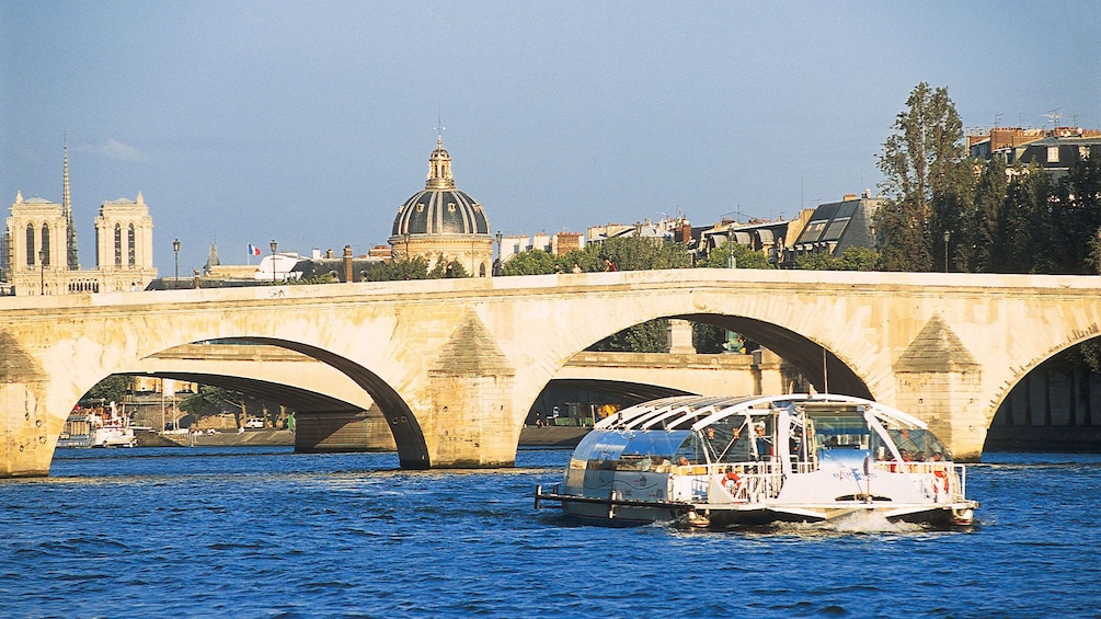 Bstobus floating down the Seine with Notre Dame in the background.