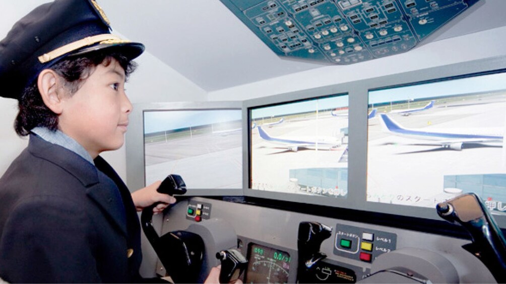 Young boy learning about being a pilot at the Kidzania in London