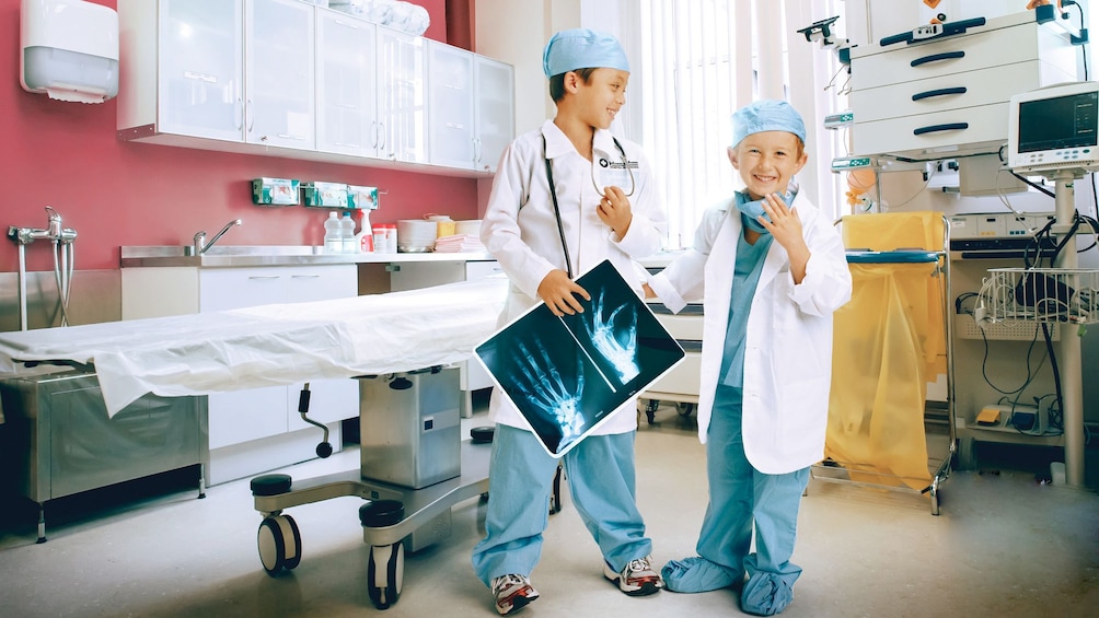 Apri foto 5 di 10. Two young boys in doctors' outfits at the Kidzania in London