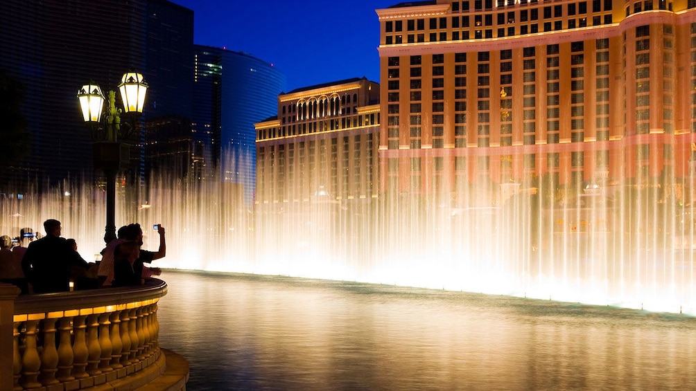 the lit water fountain display at night in Las Vegas