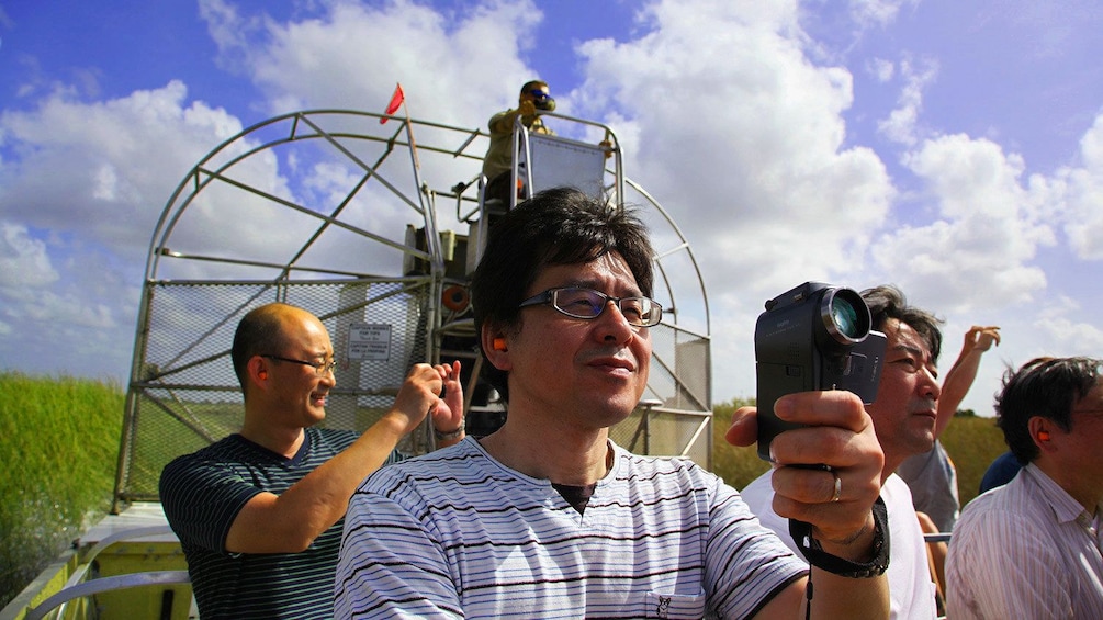 man recording his adventure on a boat in Miami