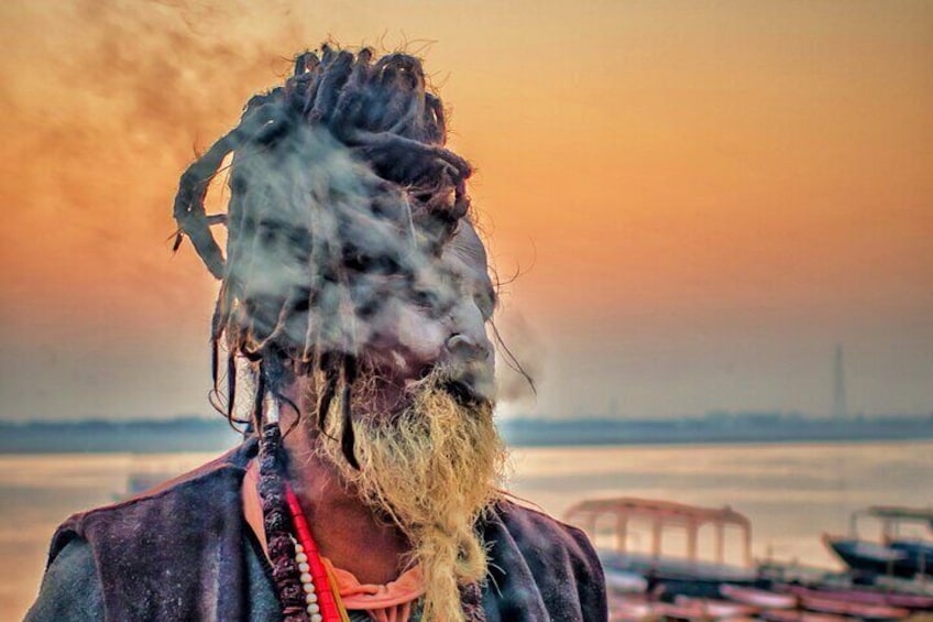 An Aghori smoking chhilam on the riverbank.