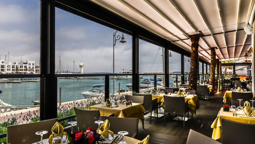 Pure Passion dining tables with a view of the marina in Agadir