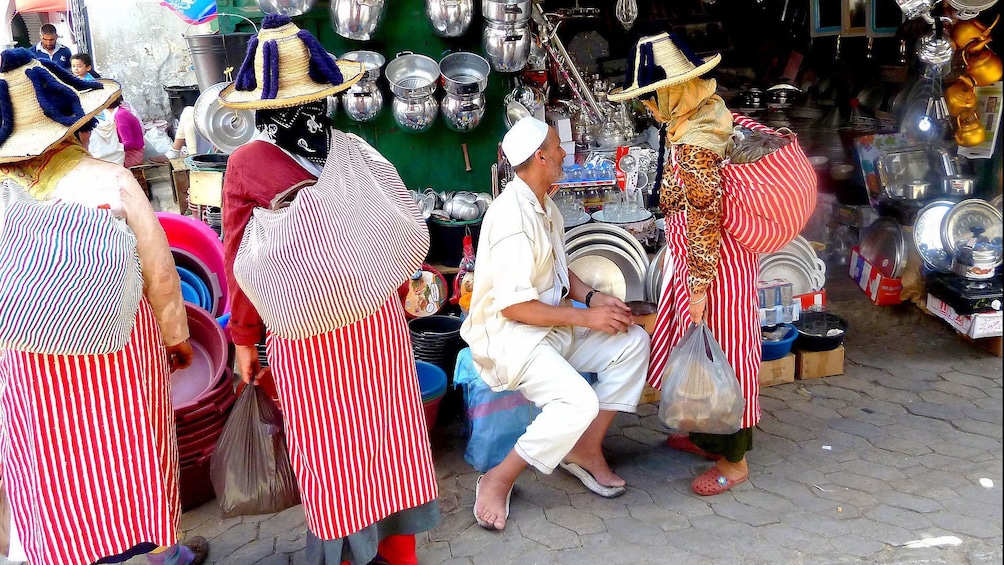 Locals haggling with a street vendor in Marrakech