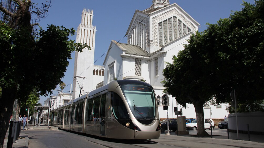 trolley outside white building 