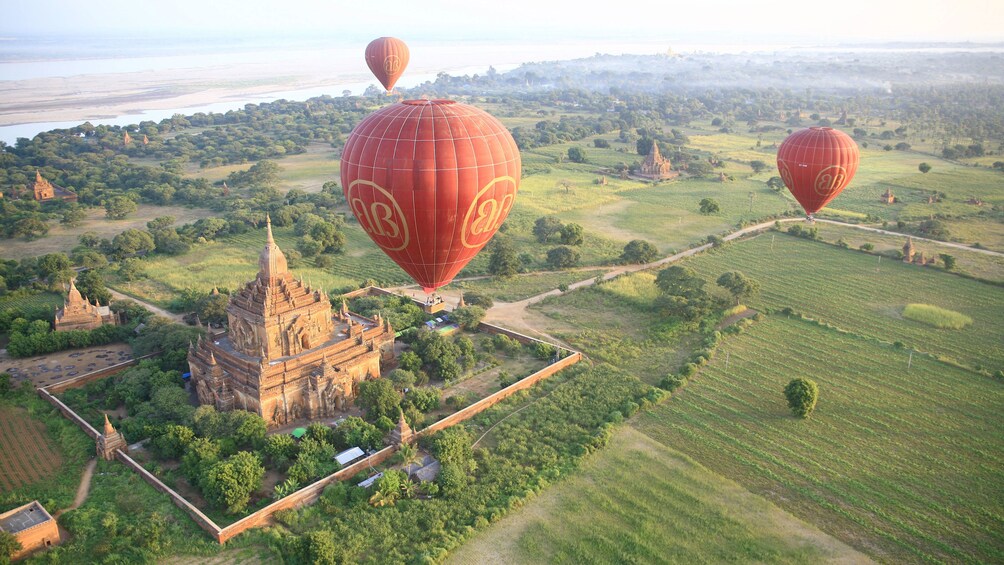 Red hot air balloons flying over Bagan 