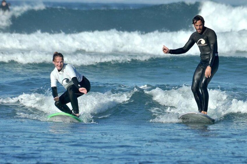 Happy surfer girl with the instructor