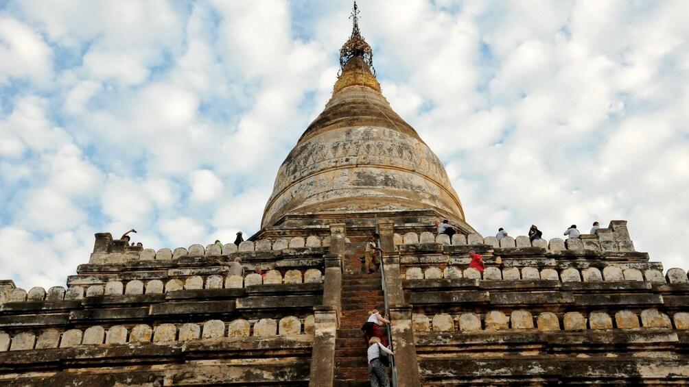 walking up a tall temple structure in Burma