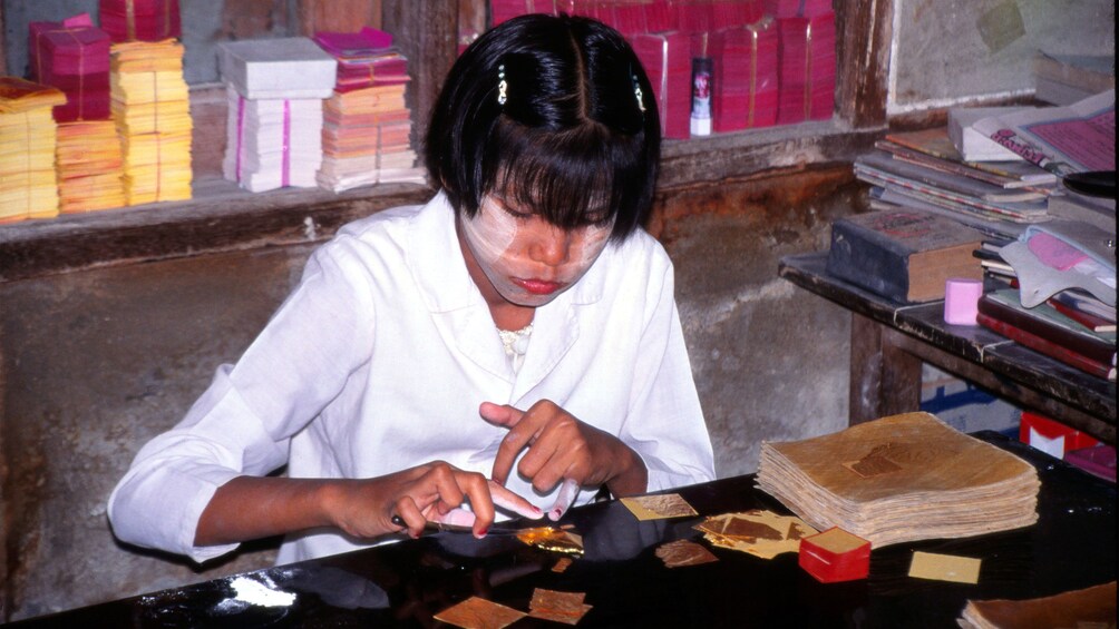 Local woman involved traditional industry in the form of gold-leaf making in Mandalay